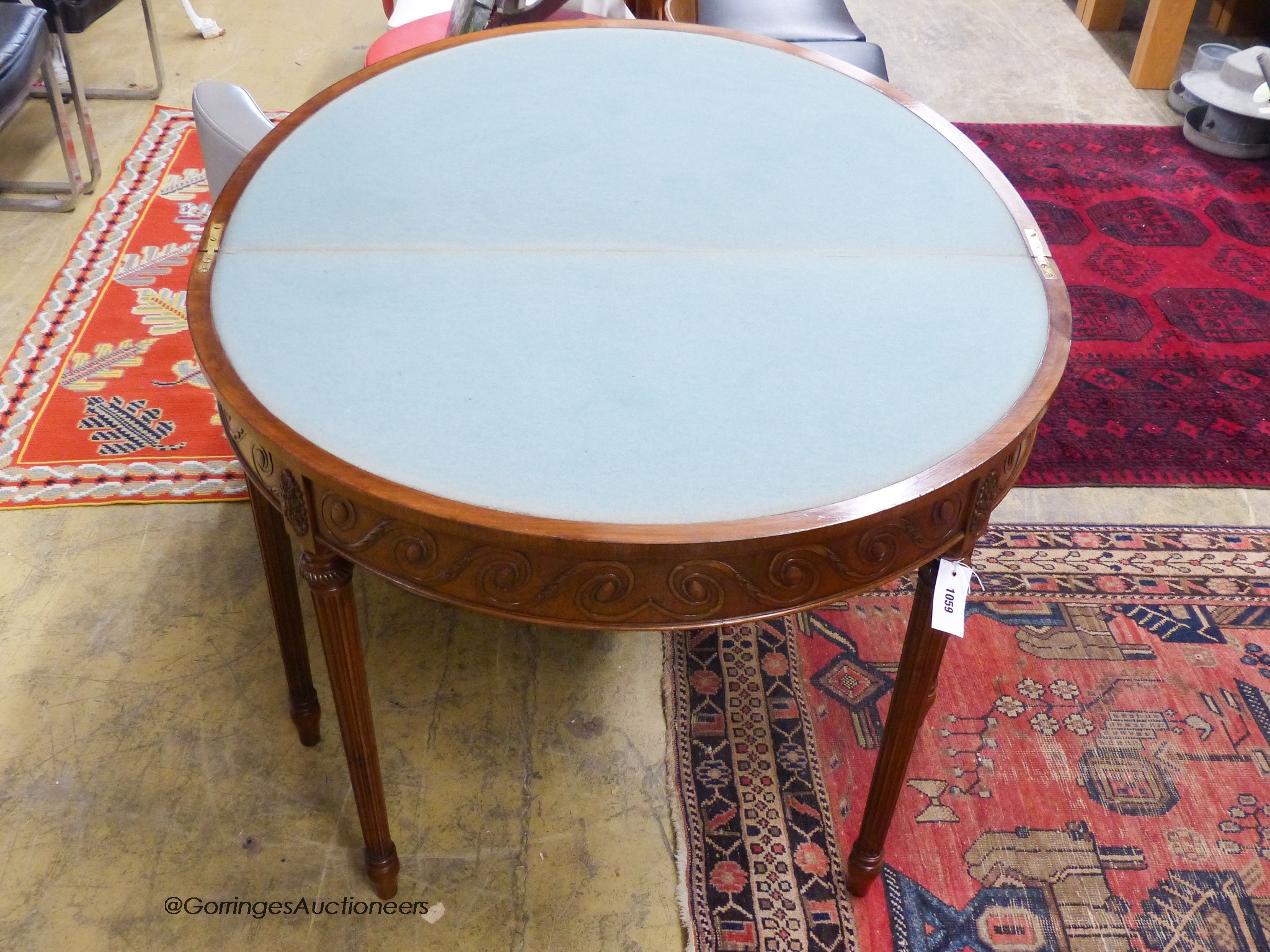 A George III style mahogany demi-lune card table. W-92, D-46, H-77cm.